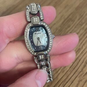 Lds pulsar silver tone with crystal band. Battery operated.Mother of pearl face